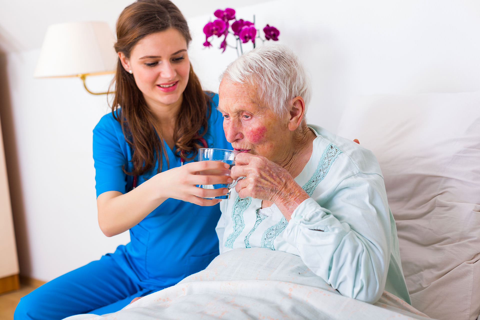 Home Care Services Newtown Square PA Divine Cooper Care PA LLC   Caregiver Bringing Water To The Senior Woman 